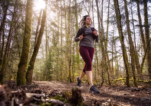 A person running through a forest path
